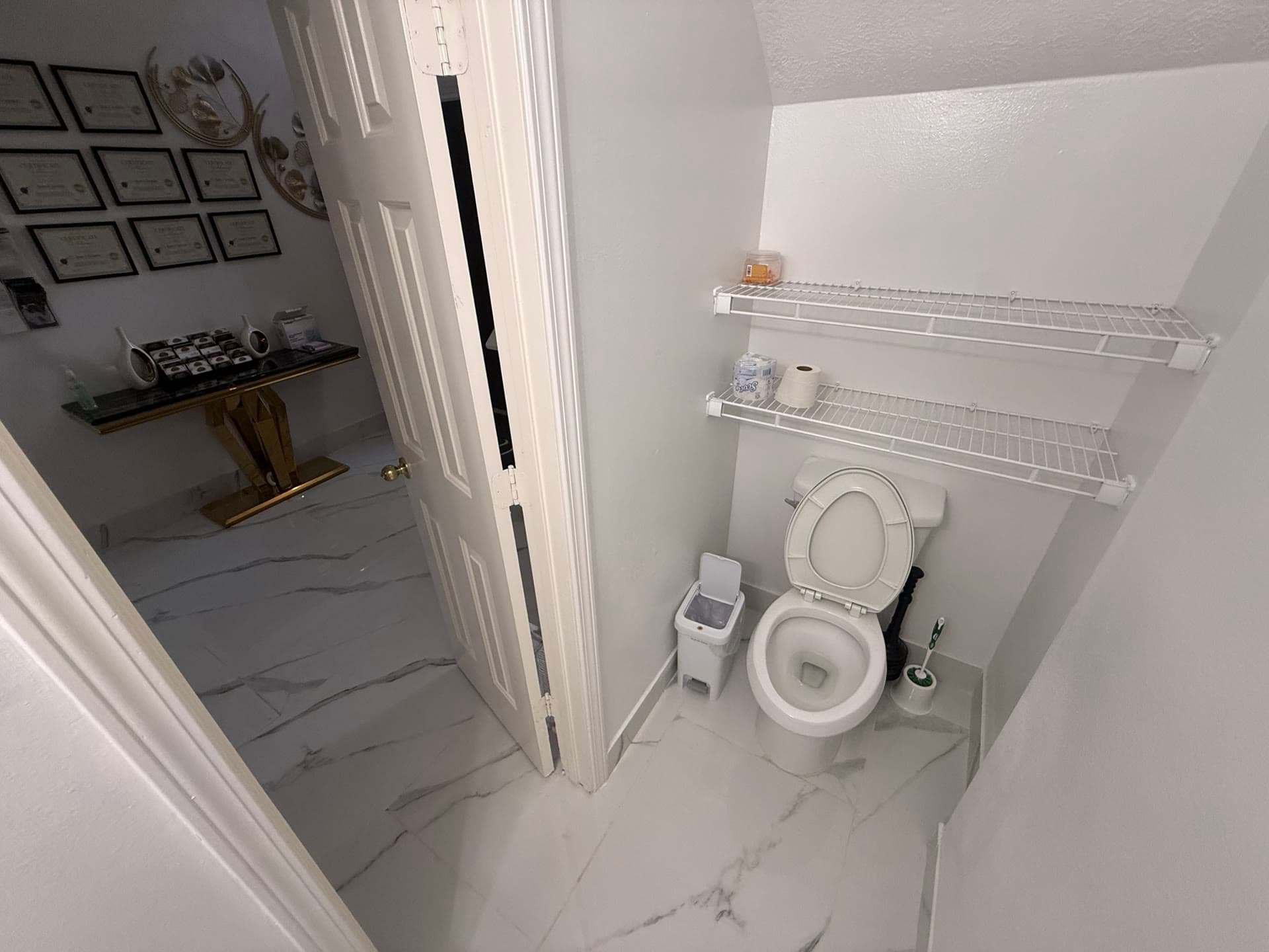 Accessible toilet room with grab bars and shelving