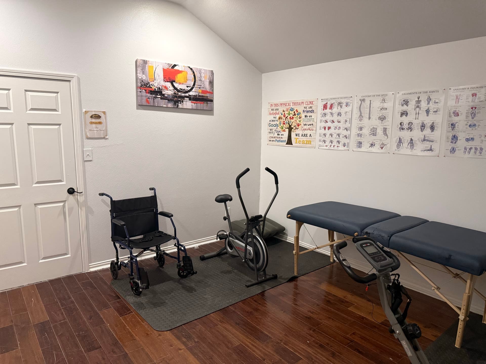 Therapy room with exercise equipment and charts