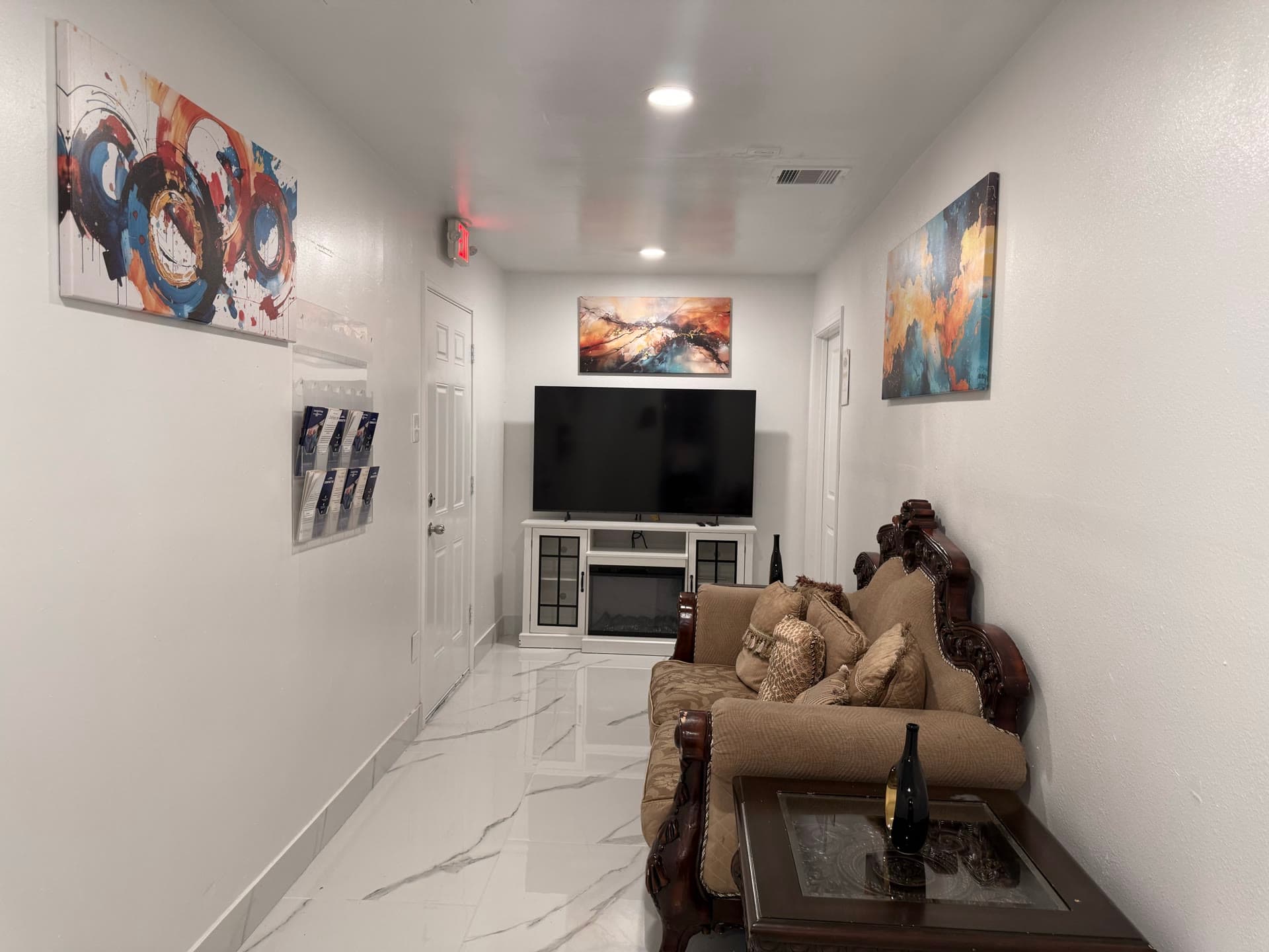 Comfortable sitting area with ornate sofa and modern art