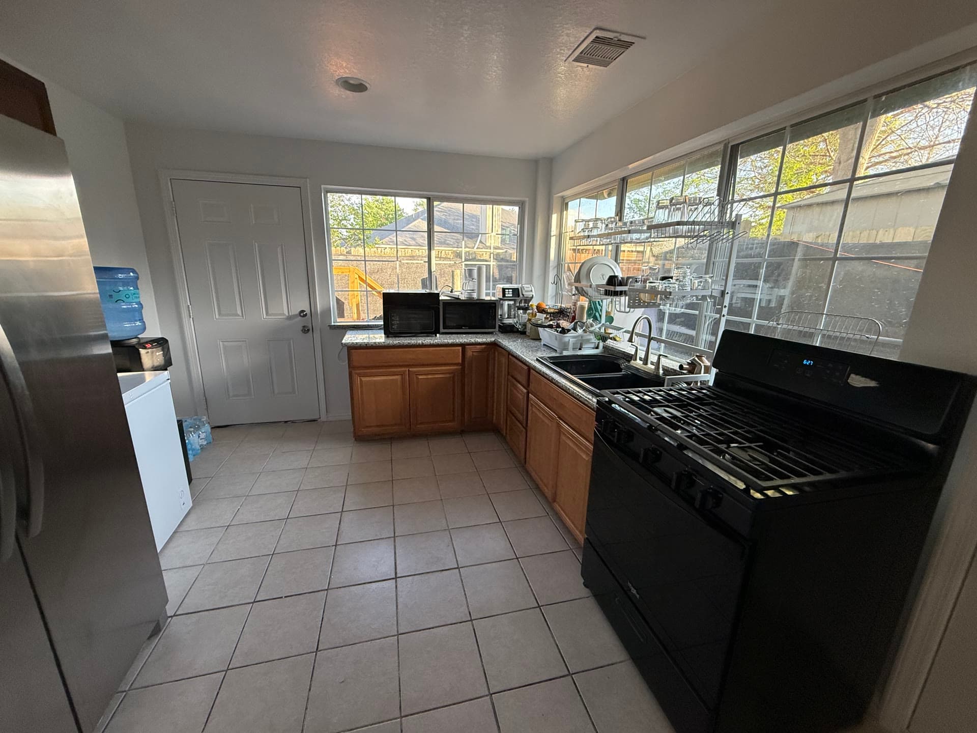 Kitchen with stainless appliances, wooden cabinets, and natural light