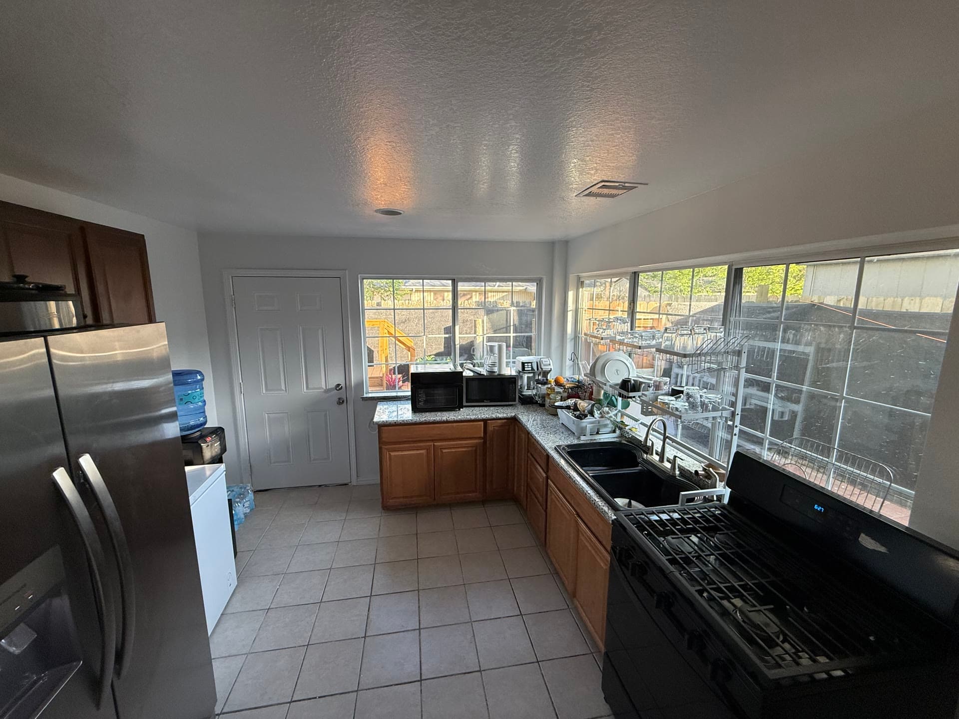 Kitchen with stainless steel refrigerator and stove