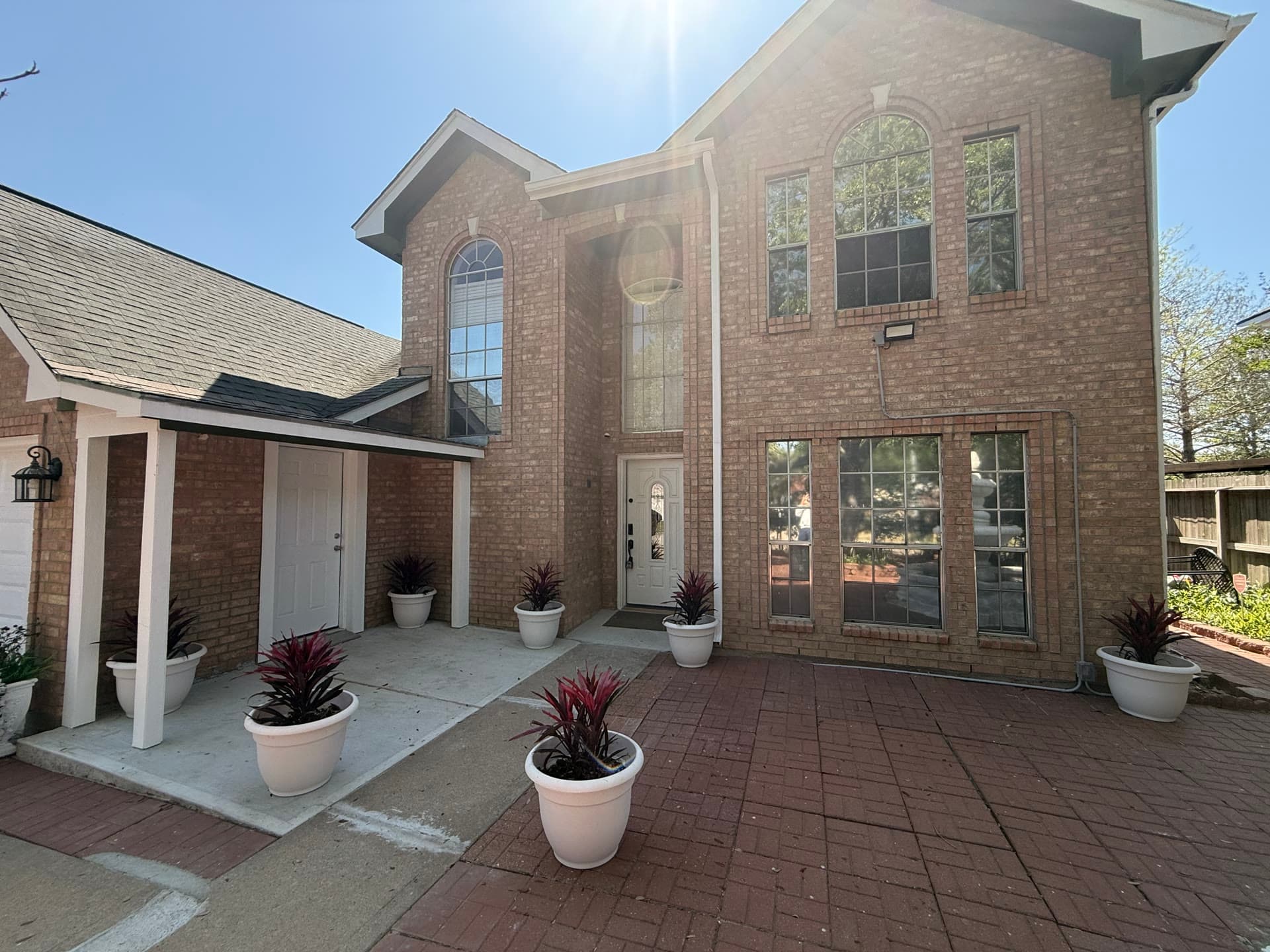 Front entrance close-up with brick facade and planters