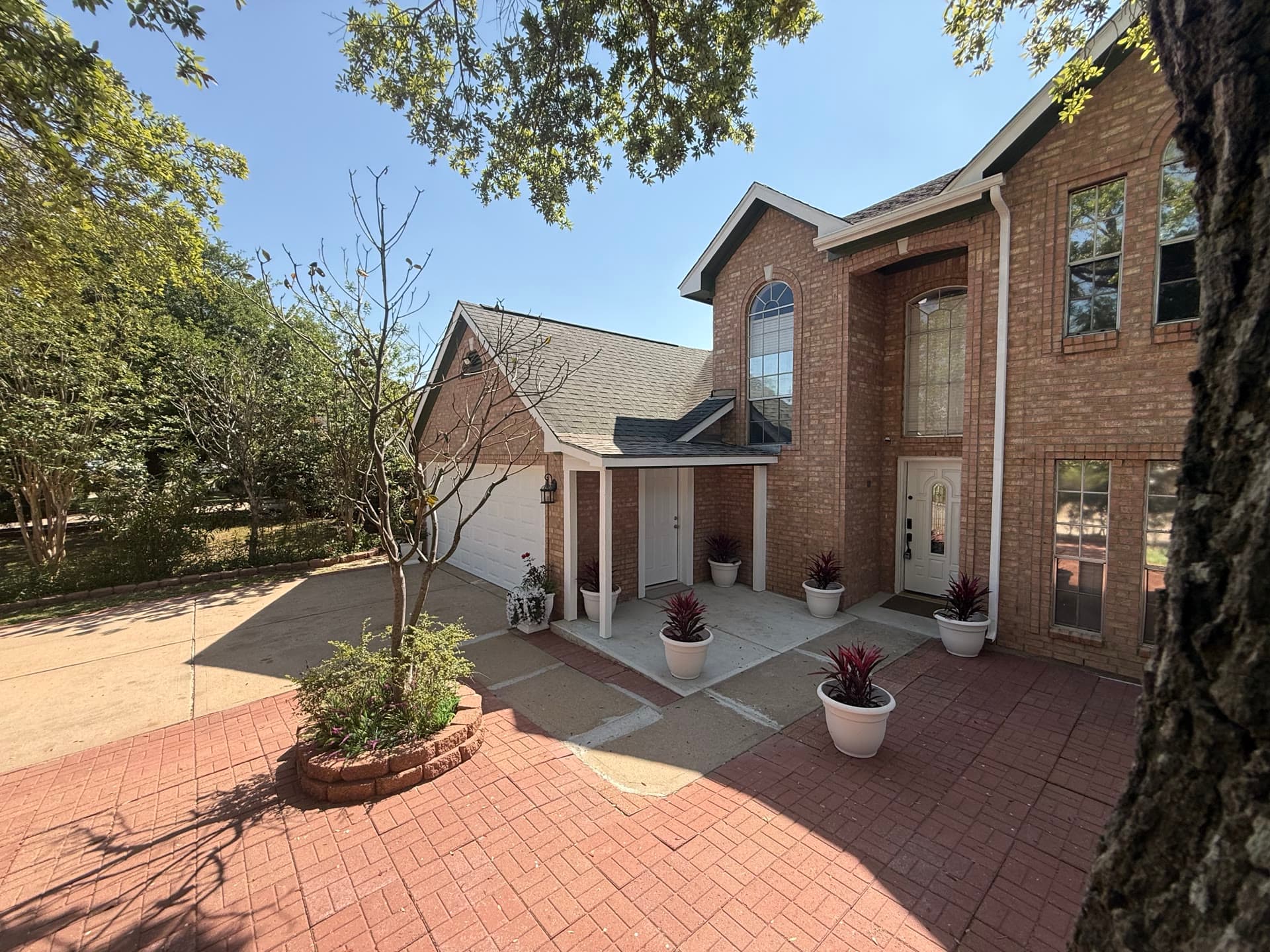 Front entrance detail with decorative planters